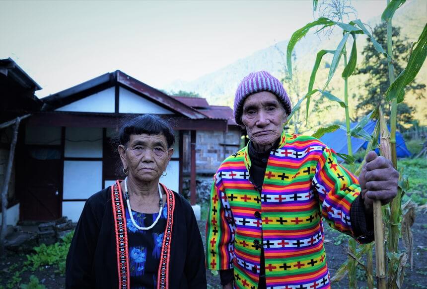 An elderly Idu Mishmi couple  Dambeun Village wearing traditional jackets. Met Mr. Sele Mili wearing Anatobo (+ motif) and alongside his wife Mrs. Ipili Molo