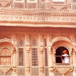 Man peeping out of a window in Mehrangarh Fort